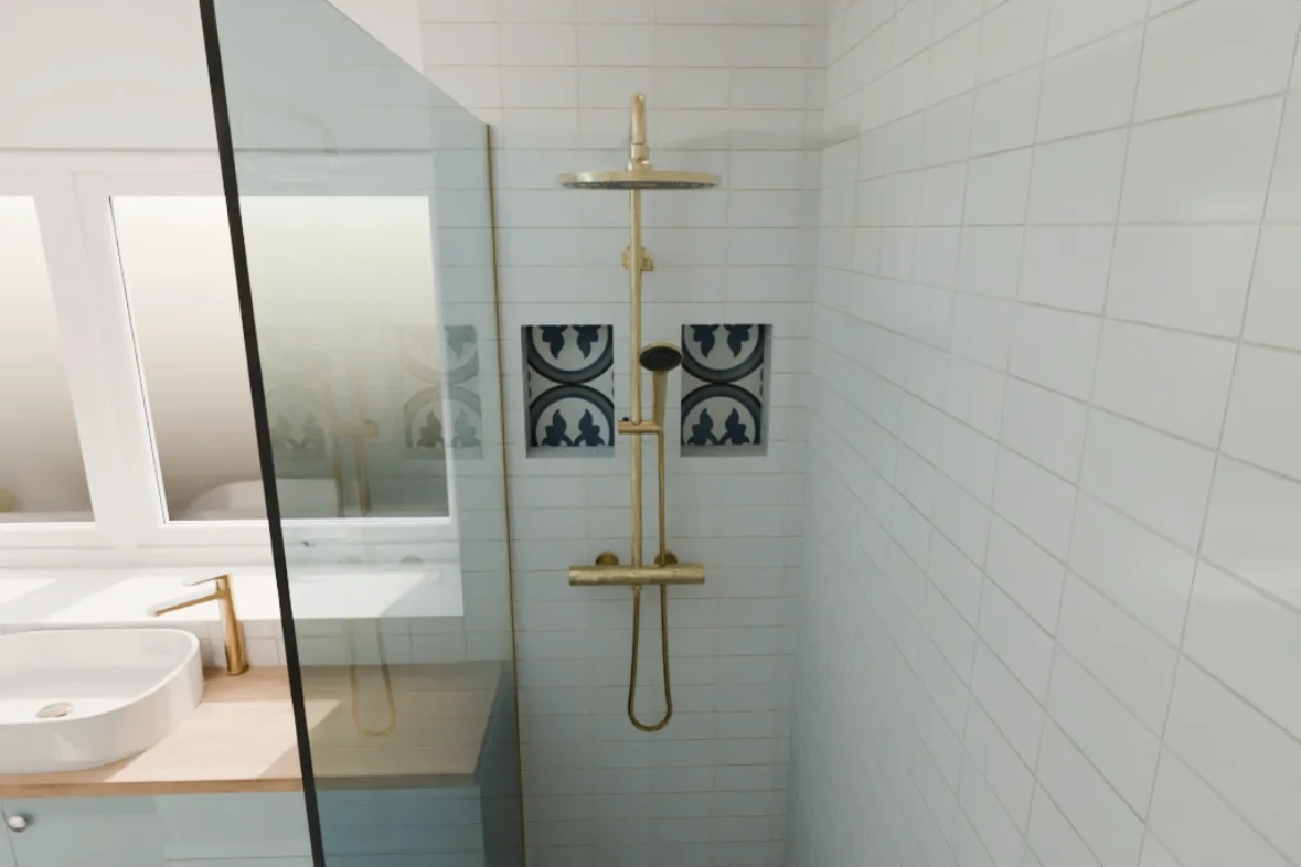 Completed tiled shower area with brushed brass fittings and glass screen